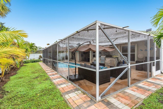 exterior space featuring a lawn, a lanai, outdoor lounge area, a fenced in pool, and a patio area