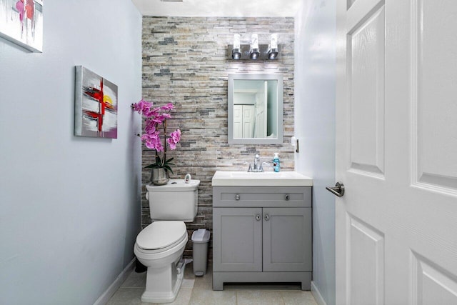 bathroom featuring toilet, tile patterned flooring, and vanity