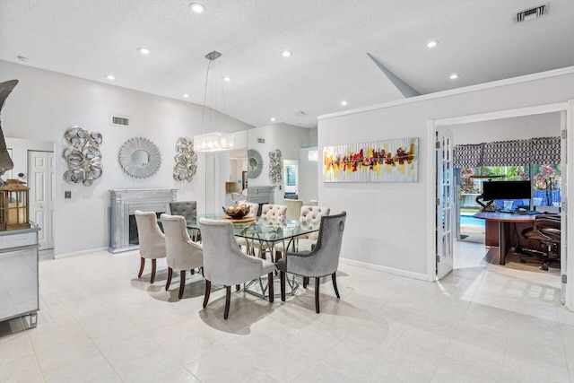 dining area with high vaulted ceiling, light tile patterned floors, and a textured ceiling