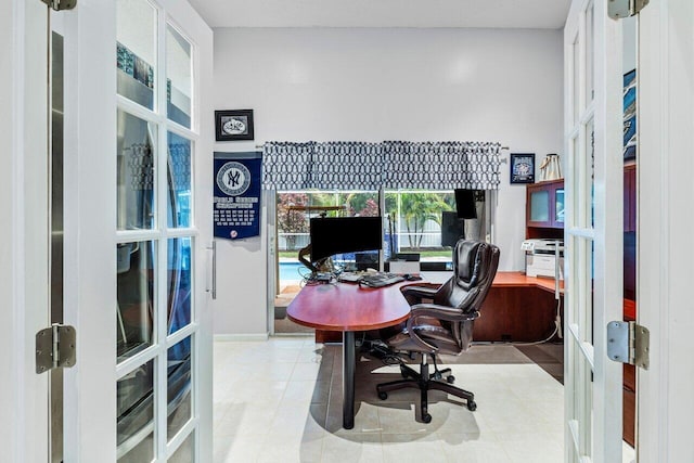 home office featuring light tile patterned floors and french doors