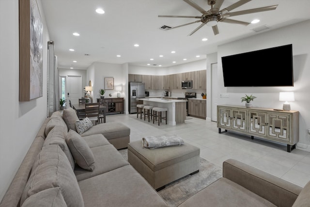 living room featuring sink and ceiling fan