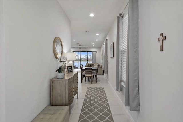 hall featuring light tile patterned floors