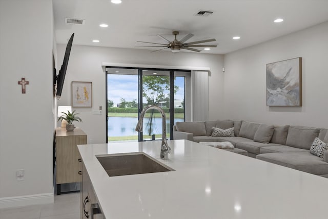 kitchen with sink, ceiling fan, and light tile patterned floors