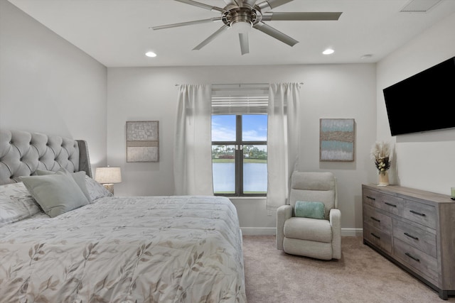 bedroom with ceiling fan and light colored carpet