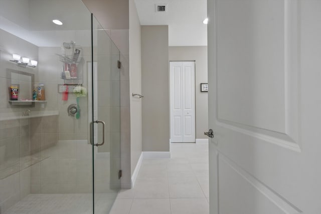 bathroom with tile patterned flooring and walk in shower