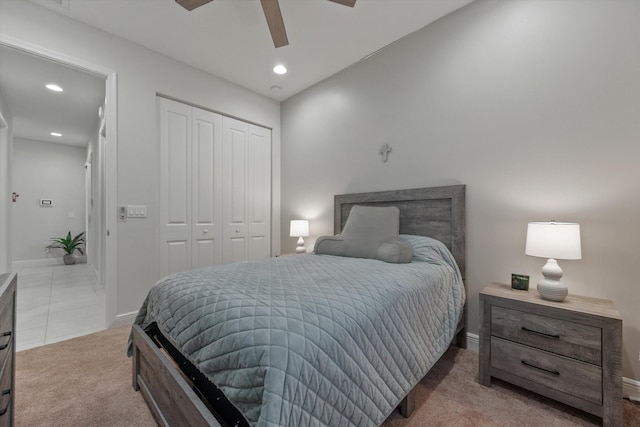 carpeted bedroom featuring a closet, ceiling fan, and lofted ceiling