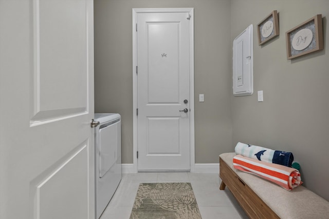 clothes washing area featuring washing machine and dryer and light tile patterned floors