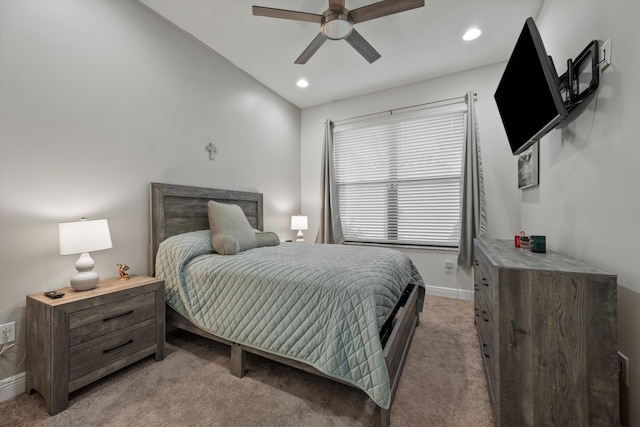 bedroom featuring light carpet, lofted ceiling, and ceiling fan