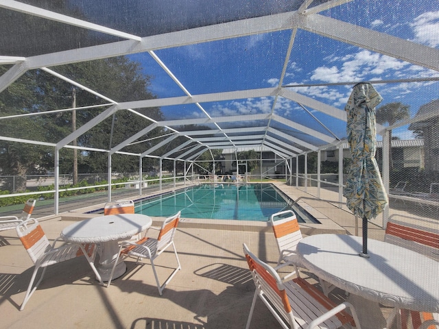 view of pool with a lanai and a patio