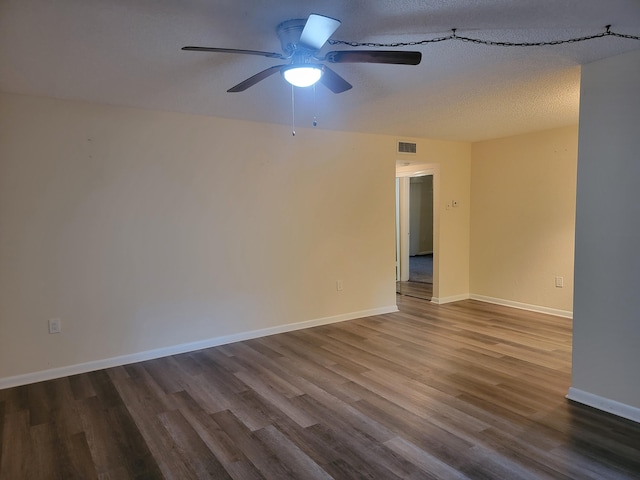 spare room with hardwood / wood-style flooring and ceiling fan