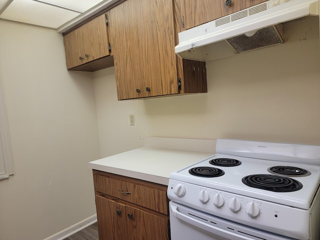 kitchen with electric range and dark hardwood / wood-style floors