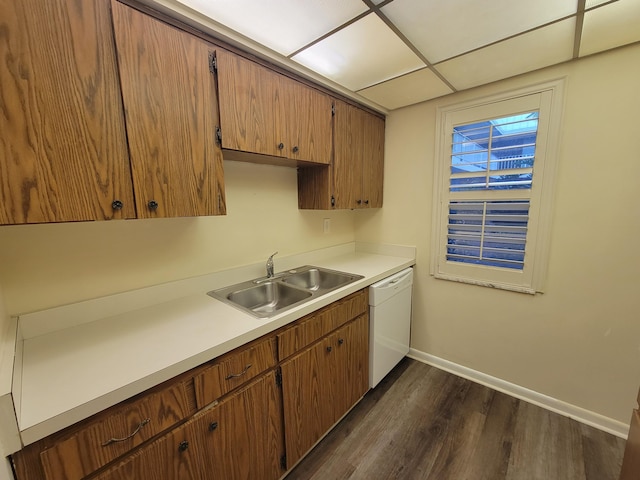 kitchen featuring dark hardwood / wood-style flooring, dishwasher, a drop ceiling, and sink