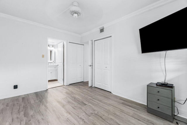 unfurnished bedroom featuring light wood-type flooring, crown molding, and connected bathroom