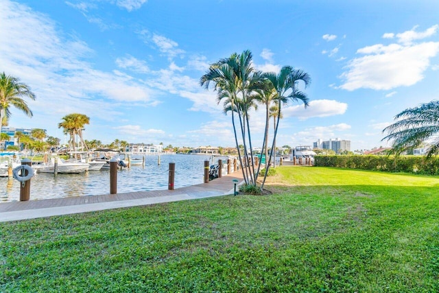 view of dock featuring a yard and a water view