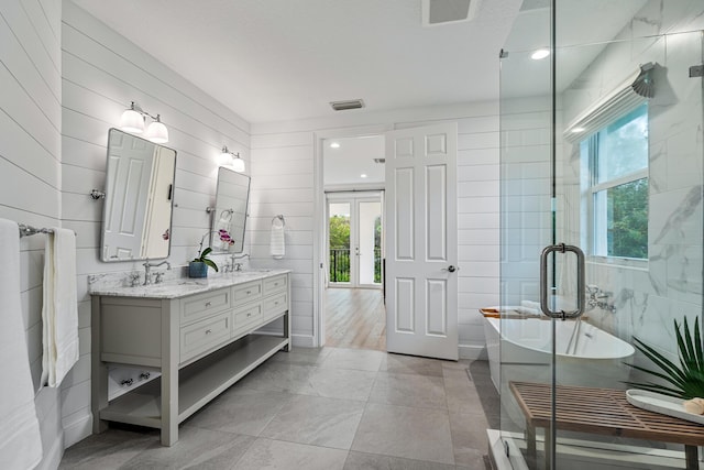 bathroom with vanity, independent shower and bath, and tile patterned flooring