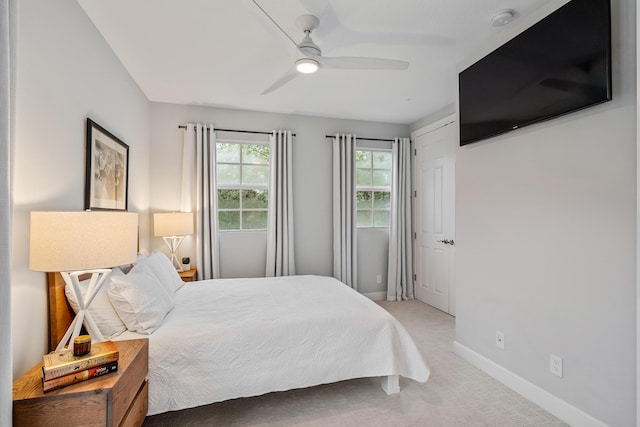 bedroom featuring ceiling fan and carpet