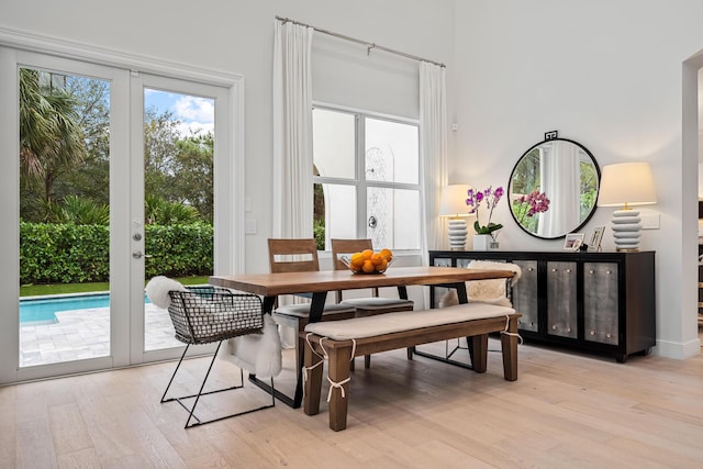 dining space featuring light hardwood / wood-style flooring and french doors