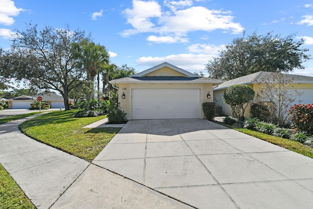 single story home featuring a garage and a front lawn