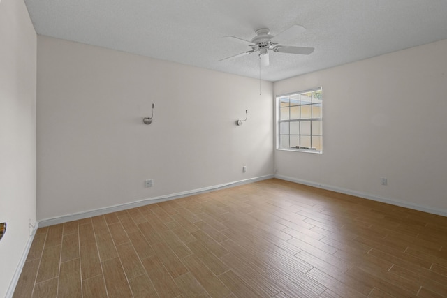 spare room with a textured ceiling, ceiling fan, and wood-type flooring