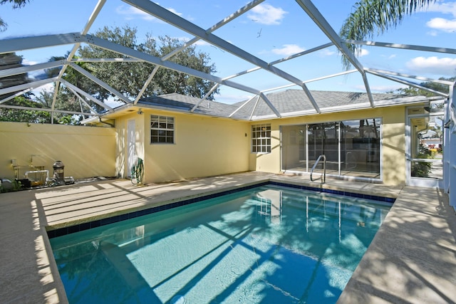 view of swimming pool with a patio and glass enclosure