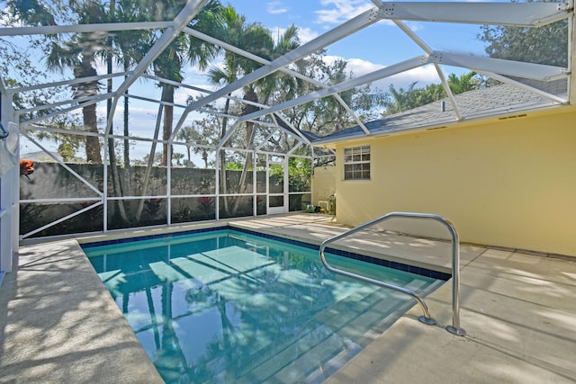 view of pool with a patio and glass enclosure