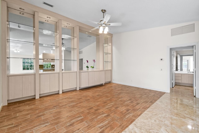 interior space featuring ceiling fan and a healthy amount of sunlight