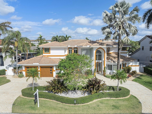 mediterranean / spanish-style home with a front lawn