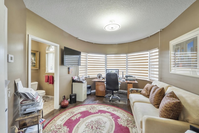 office featuring a textured ceiling and dark hardwood / wood-style flooring