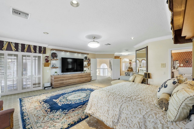 bedroom featuring a textured ceiling and crown molding