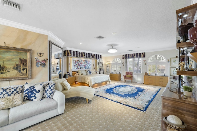 bedroom with a textured ceiling and crown molding