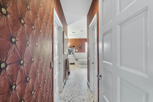 hallway with a textured ceiling