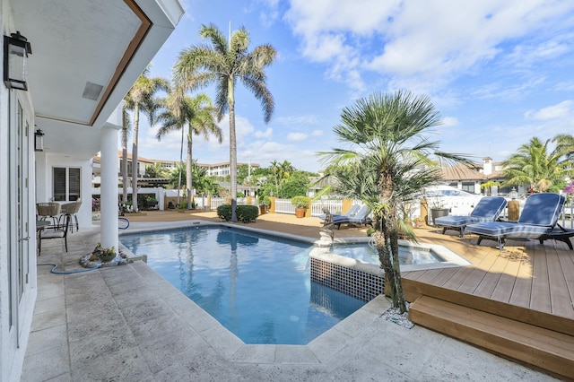 view of pool featuring a deck, an in ground hot tub, and a patio