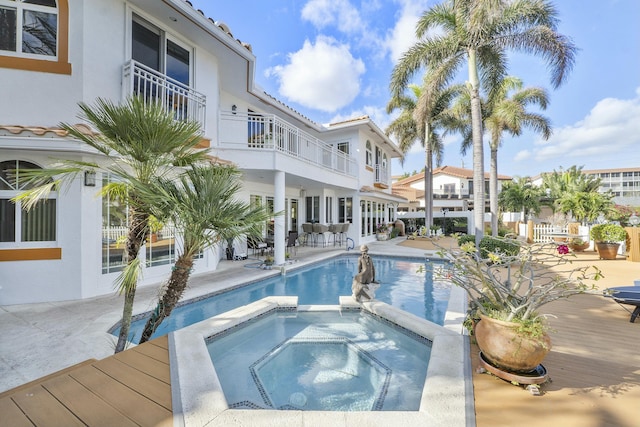 view of swimming pool featuring a patio and an in ground hot tub