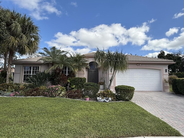 view of front of house with a front lawn and a garage