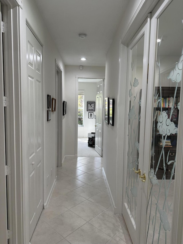 hallway featuring light tile patterned floors