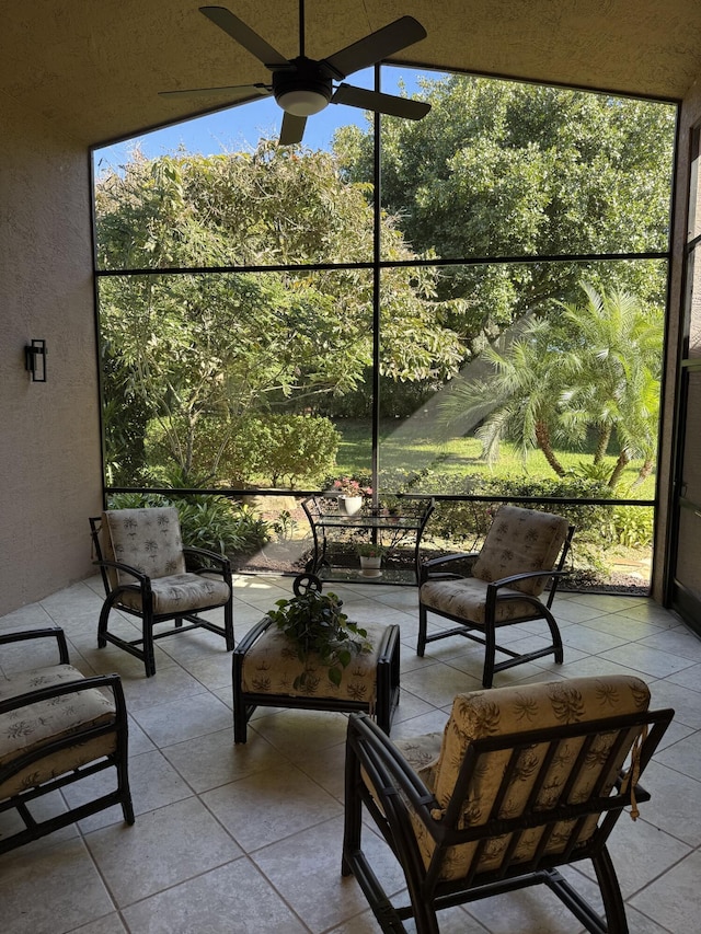 sunroom / solarium featuring ceiling fan