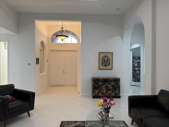 tiled entryway with a towering ceiling