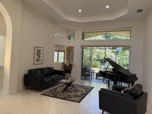 tiled living room with a tray ceiling