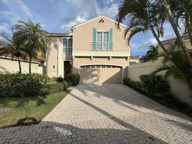 mediterranean / spanish-style house with a balcony and a garage