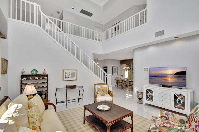 tiled living room with a towering ceiling and a notable chandelier