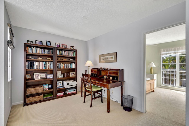 home office with light carpet and a textured ceiling