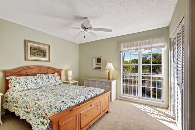 carpeted bedroom featuring a textured ceiling, a closet, and ceiling fan