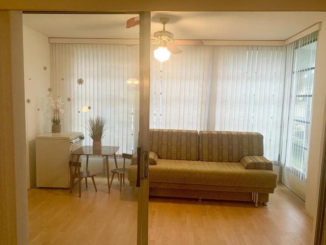 living area featuring ceiling fan and wood-type flooring