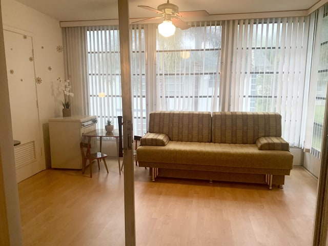 living area with ceiling fan and light wood-type flooring