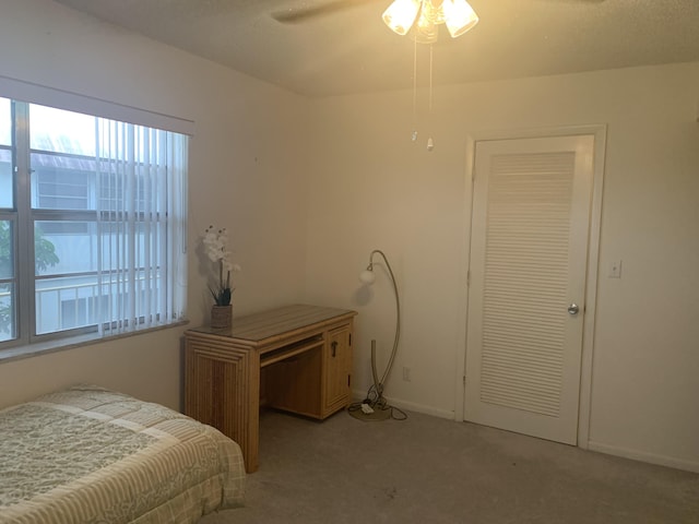 bedroom with light carpet and ceiling fan