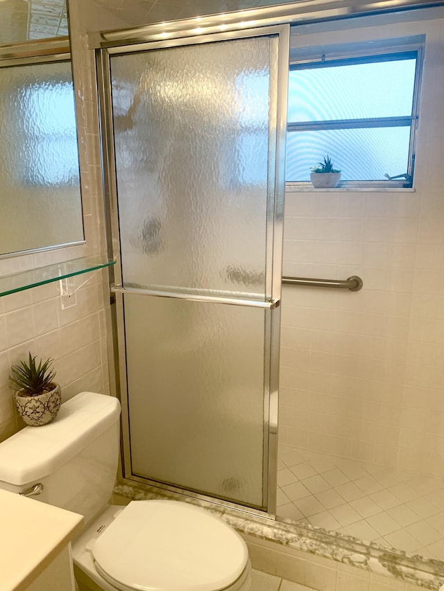 bathroom featuring toilet, tile walls, walk in shower, and vanity