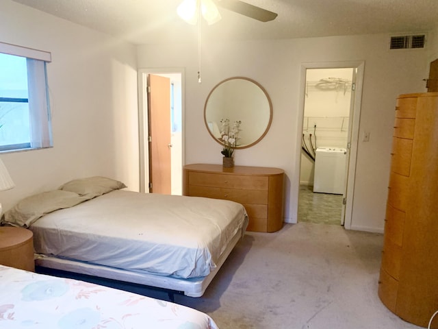 carpeted bedroom featuring ceiling fan and washer / dryer