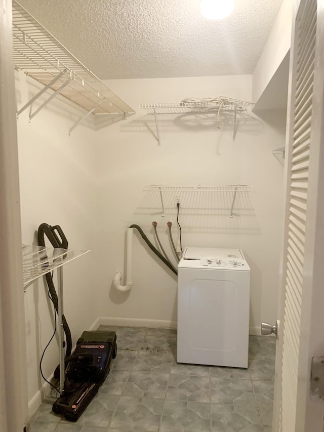 laundry area featuring washer / dryer and a textured ceiling