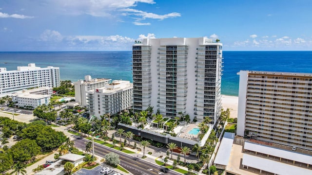 drone / aerial view featuring a water view and a view of the beach