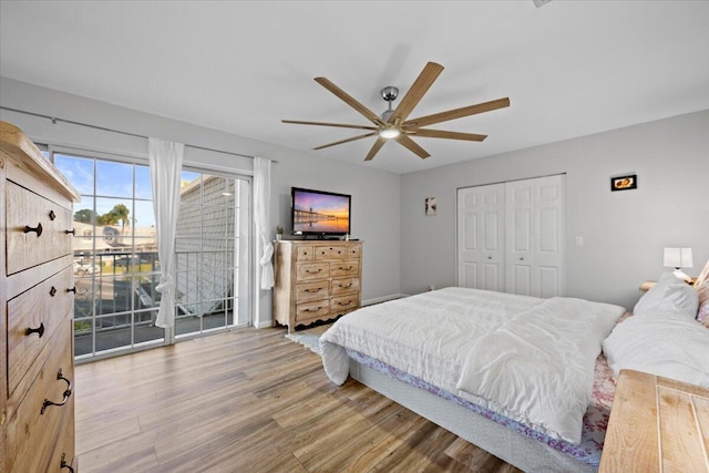 bedroom featuring ceiling fan, access to exterior, a closet, and light wood-type flooring